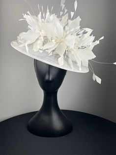 A white sinimay saucer topped with beautiful cut white feathers and white orchids. Sits on a comfortable white headband. Ships in a high quality storage box. One of a kind. Perfect for Kentucky Derby, Royal Ascot, church, weddings, just for fun. Luxury White Brimmed Fascinator, White Fitted Fascinator For Royal Ascot, White Fitted Mini Hat For Races, White Handmade Flowers Fascinator For Royal Ascot, White Fascinator With Handmade Flowers For Royal Ascot, White Handmade Flower Fascinator For Kentucky Derby, White Feather Fascinator For Formal Events, White Summer Fascinator With Handmade Flowers, White Feathered Fascinator For Formal Occasions