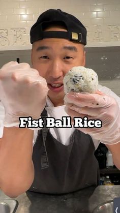 a man in an apron and hat holding up a piece of food with the words first ball rice on it