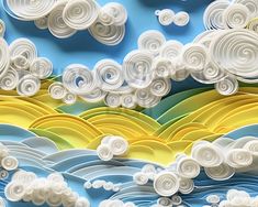 an artistic paper art scene with clouds in the sky