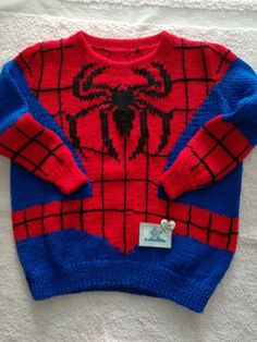 a red and blue sweater with spiderman on it