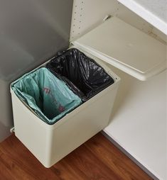 Designed to fit smaller cabinet spaces, this compact two-bin waste container is useful for keeping trash separated from recyclable materials. The container pivots on a hinge mechanism that connects to the cabinet door and inside wall of the cabinet; as the door opens, the cover automatically lifts, allowing the bins to travel with the door. Each bin insert holds 7.5 litres (7.9 quarts) and has folding bail handles for easy removal. Installs on right- or left-hand doors a minimum of 425mm (16 3/4 Under Sink Trash Can Pull Out, Arizona Kitchen, Low Cupboard, Garage Storage Inspiration, Frameless Cabinets, Small Cupboard, Lee Valley Tools, Bathroom Trash Can, Waste Container