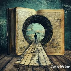 an open book sitting on top of a wooden table next to a person standing in front of it