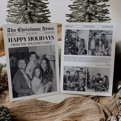 two christmas cards sitting on top of a table