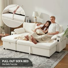 a man and woman sitting on a white couch in the middle of a living room