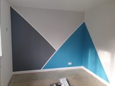 an empty room with blue and white walls