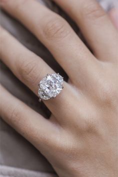 a woman's hand with a diamond ring on it