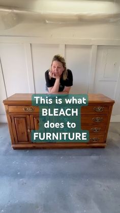 a woman sitting at a table with a sign on it that says, this is what bleach does to furniture