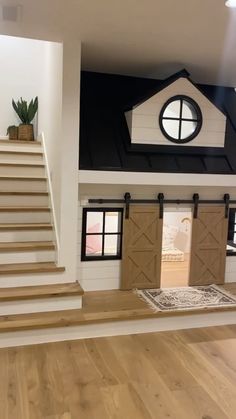 the inside of a doll house with stairs and windows