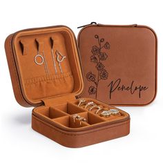 an open brown case with jewelry inside