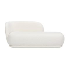 a white couch sitting on top of a white floor