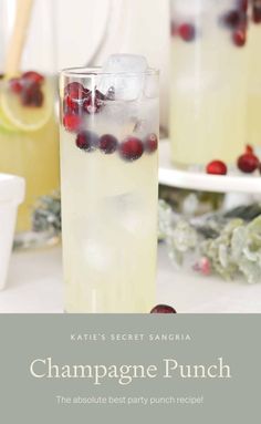 champagne punch recipe with cranberries and lemons on the side, served in tall glasses