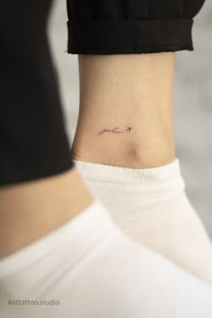 a woman's ankle tattoo with the word love on her left side ribcage