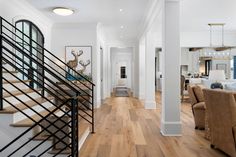 a living room filled with furniture next to a staircase