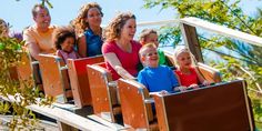 a group of people riding on top of a roller coaster