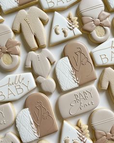 baby shower cookies are arranged on a table