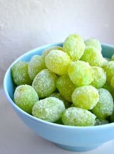 a blue bowl filled with powdered sugar balls