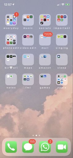 an iphone screen with various icons on it and clouds in the backgrouund