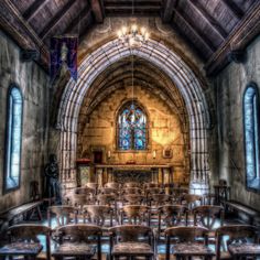 the interior of an old church with stained glass windows