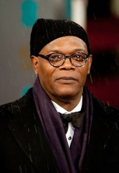 an older man wearing glasses and a black hat with a purple scarf around his neck