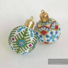 two beaded christmas ornaments sitting next to each other