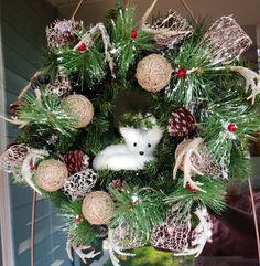 a christmas wreath with an animal in the center