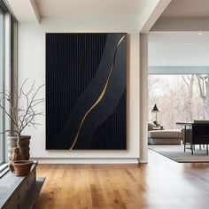 a large painting hanging on the wall in a living room next to a wooden floor