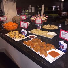 several plates of food on a counter with signs in front of them that say it's national fried chicken day