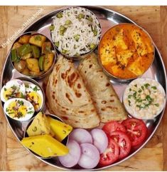 a metal plate topped with different types of food