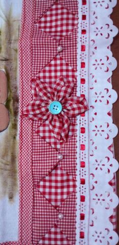 a red and white checkered table cloth with a teddy bear on the front, blue button