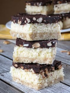 four pieces of cake sitting on top of a wooden table