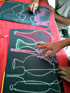 children are drawing with chalk on the table