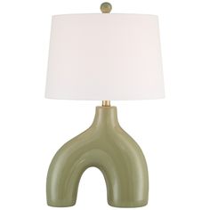 a green table lamp with a white shade on the top and an oval shaped base