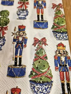 a table cloth with christmas decorations and nutcrackers in blue, green and red