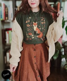 Discover the charm of our Cute Flower Fox Shirt, a delightful blend of vintage floral and cottagecore aesthetics. Adorned with a fox amidst a wildflower meadow, it's perfect for woodland lovers and fans of fairycore. A thoughtful and stylish gift for her, this T-shirt adds a touch of forestcore magic to any wardrobe. 🦊🌼  Here's what you need to know  ★ Fit ★ This is a unisex T-shirt. It might be a bit larger than your usual size. So, check out our size chart to find your perfect fit. Want an oversized look? Pick a size larger than you normally would. For a snug fit, go a size down.👕🔍 ★ Fabric ★ We're all about comfort and quality. ● It's lightweight and thin - perfect for summer, with a fabric weight of just 4.2 oz/yd² (142 g/m²). ☀️🍃 ● For solid colors, we use 100% Airlume combed and Fox Shirt, Cottagecore Shirt, Estilo Indie, Cottagecore Outfits, Estilo Hippie, Mode Boho, Granola Girl, Mode Inspo, Aesthetic Outfits