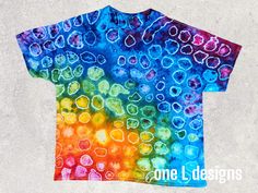 a colorful t - shirt with hearts painted on it