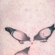 two small birds on the back of a woman's thigh, with spots all over it