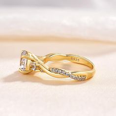 a yellow gold ring with two diamonds on it