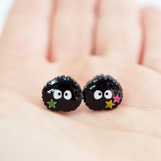 So cute!! Make your ears happy with these adorable earrings featuring cute little Studio Ghibli inspired Susuwatari (Black Soot Sprites), handcrafted by our talented artist Fancypop! These cute earrings are accented with little star sequins and are resin coated for a glossy finish. Your new favorite earrings! About These Earrings: Size: 12mm x 11mm (~0.47in x 0.473in) Materials: Resin, Glitter, Star Sequins Stainless Steel posts with butterfly backings One Pair Playful Black Earrings For Gift, Handmade Fun Black Earrings, Fun Handmade Black Earrings, Handmade Black Star-shaped Earrings, Quirky Handmade Black Earrings, Cute Black Resin Jewelry, Cute Black Earrings As A Gift, Cute Black Hypoallergenic Earrings, Cute Black Earrings For Gift