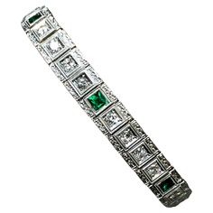 An original line bracelet from the Art Deco era done in 14K white gold and set with approximately 2.80cttw in all original old European cut diamonds averaging G-I in color and Vs1-2 in clarity. There are also 7 square cut synthetic emeralds bezel set between the diamond sections (typical for the period). Bracelet has a box clasp with swing up safety catch. Dimensions/Weight: Bracelet measures 7” long by .35” wide and weighs 18.9g. Condition: All stones are secure. Carefully enjoyed for many years; wonderful condition. B-CC Art Deco Emerald, Bracelet Tennis, Box Clasp, Art Line, European Cut Diamonds, Art Deco Era, Square Cut, Tennis Bracelet, Bezel Setting