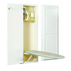 a white ironing board is in an open cabinet