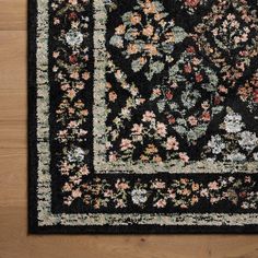 a black area rug with floral designs on it