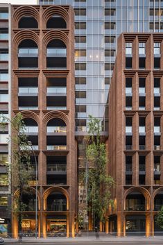 two tall buildings next to each other in front of a street with cars on it