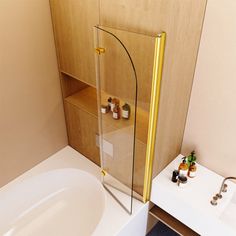 a bath tub sitting next to a white sink under a bathroom mirror on top of a wooden cabinet