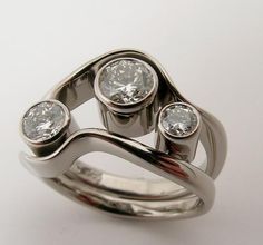 an unusual ring with three diamonds on it