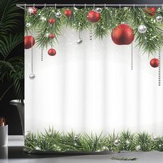 a shower curtain with christmas ornaments hanging from it's sides and greenery on the outside