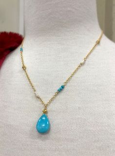 This beautiful necklace is designed with a 10mm X 15mm smooth nugget of Sleeping Beauty Turquoise (that beautiful bright blue color) and wired into a pendant with a Vermeil Bali gold bead. The pendant dangles from sparkly cable chain. Sections of the necklace are accented with tiny (2mm) smooth, round turquoise, Vermeil Bali beads that match the pendant, and tiny (2mm) white freshwater pearls for a unique one of a kind design. The look of Turquoise with gold is a beautiful change to the traditio