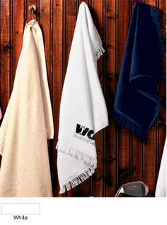 several towels hanging on a wooden wall