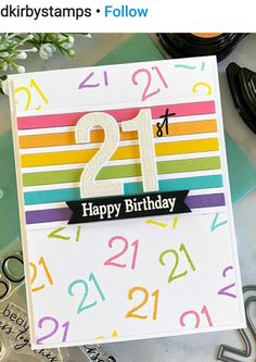 a birthday card with the number 21 on it, and some scissors next to it