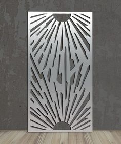 an abstract metal design on the side of a wall in a room with wood flooring