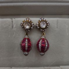 Enhance your look with our Polki and Ruby small hangings, featuring Polki stones paired with rubies. These earrings offer a perfect blend of tradition and elegance in a compact design, ideal for any outfit. Perfect for daily wear or special occasions, these hangings are a must-have for lovers of classic Indian jewelry. Material: 92.5 hallmarked silver Stones: Moissanite polkis, semi precious rubies, CZ Jeweled Drop Danglers For Gift, Festive Jeweled Bridal Earrings For Formal Occasions, Elegant Red Ruby Jhumkas, Formal Jeweled Earrings For Festivals, Red Hand Set Temple Jewelry Earrings, Hand Set Pendant Earrings For Festivals, Red Temple Jewelry Earrings With Hand Set Details, Traditional Ruby Drop Earrings, Traditional Ruby Drop Danglers